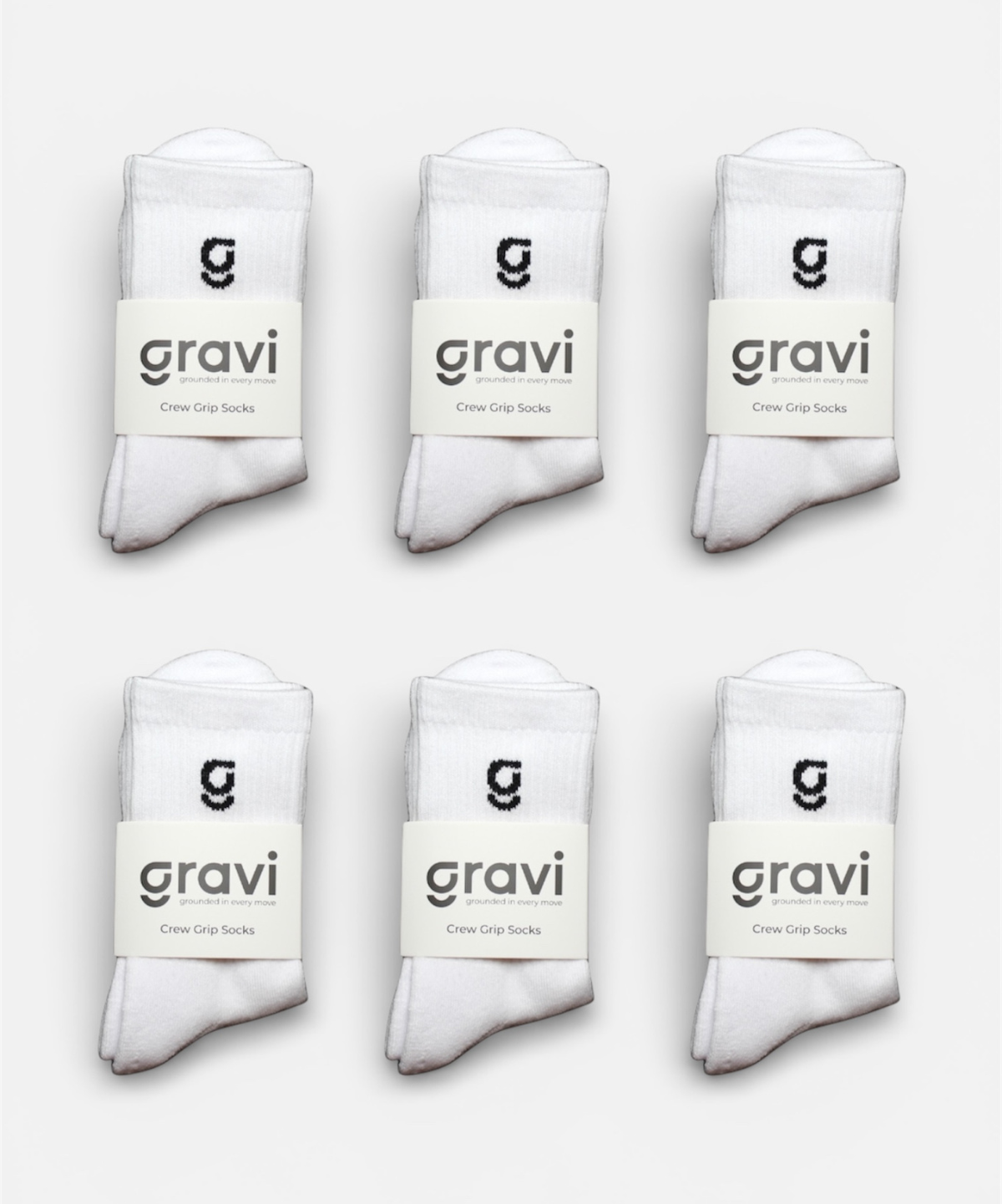 Set of six white socks with 'gravi' branding on a light gray background