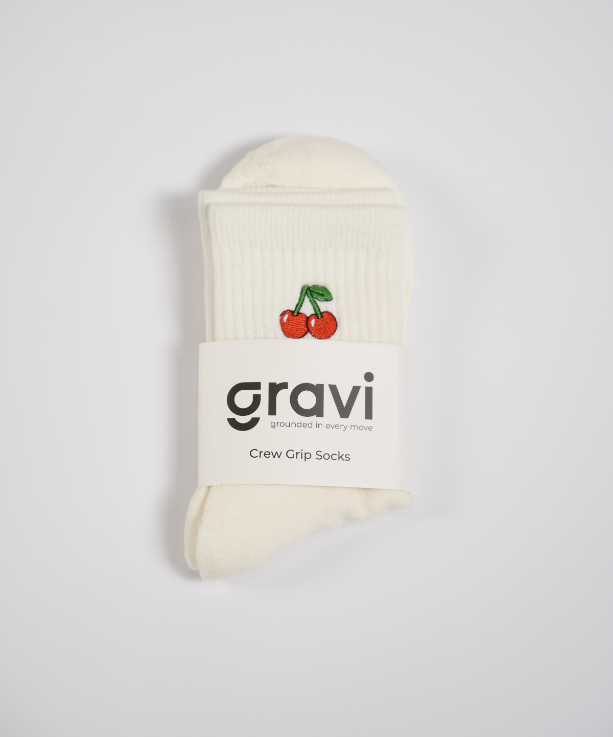 White sock with cherry design and 'gravi' branding on a light gray background