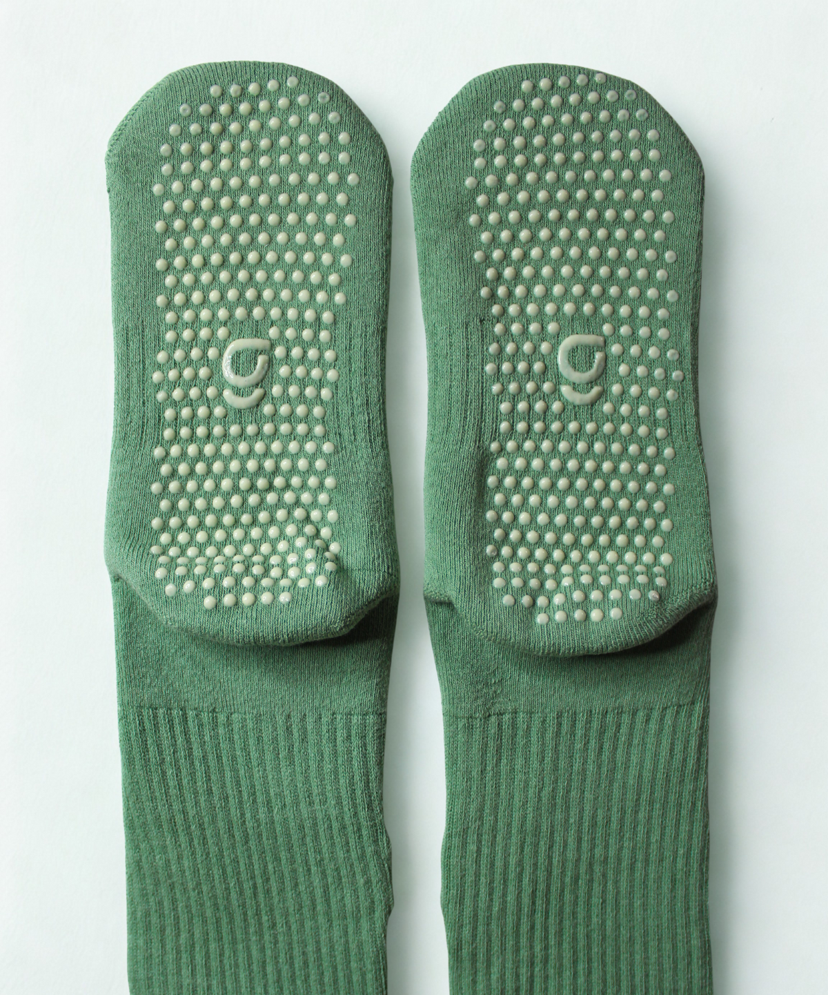 Green sock with a small design on a white background