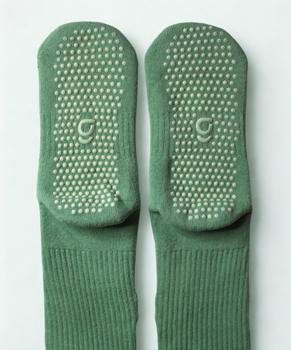 Green sock with a small design on a white background