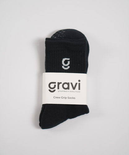 Black socks with a 'gravi' label on a light gray background