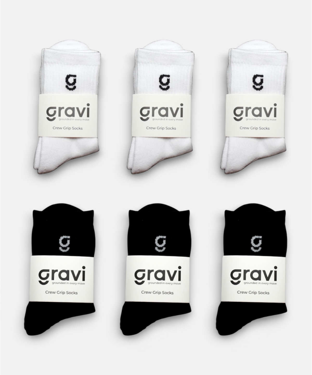 Set of white and black socks with 'gravi' branding on a light gray background