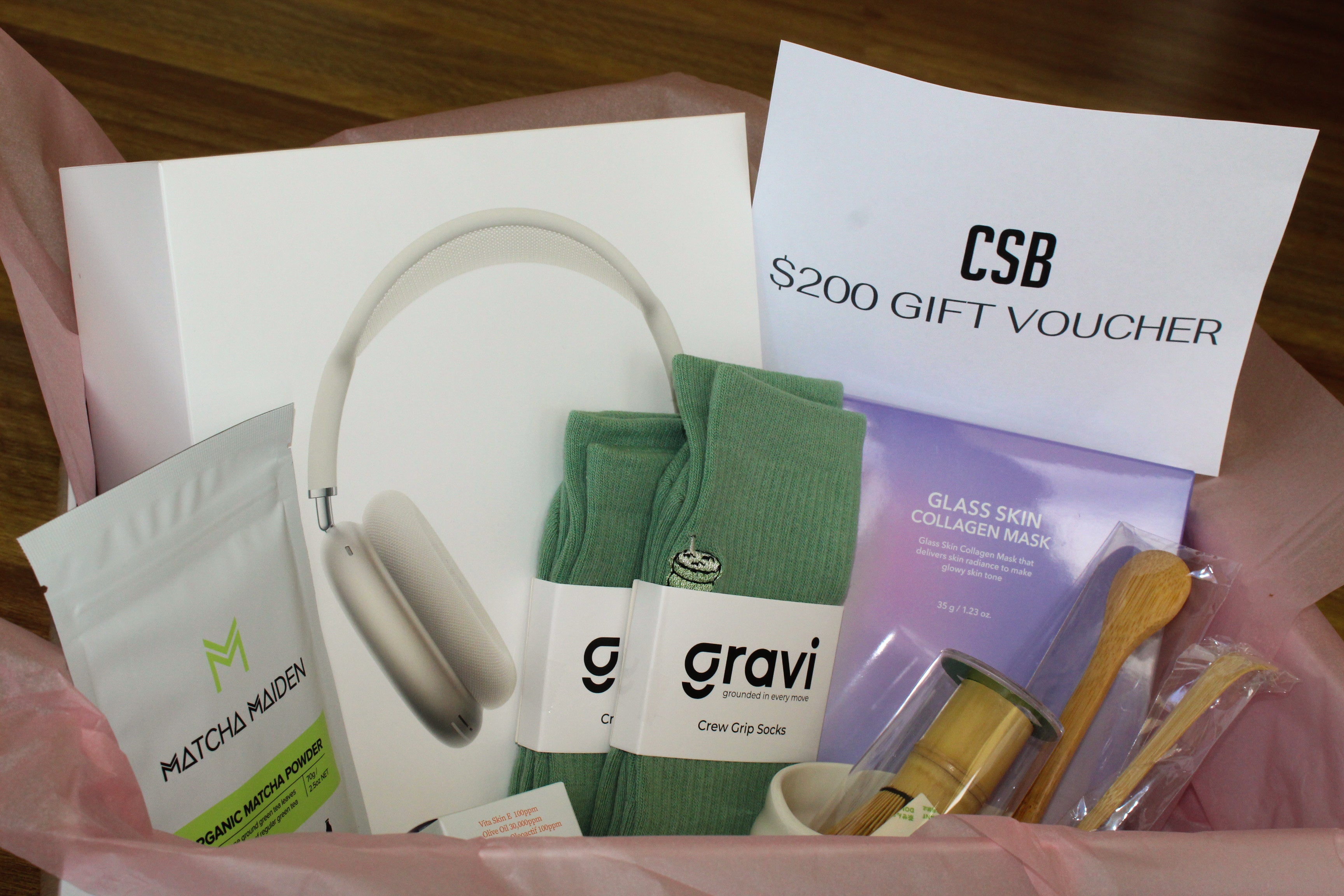Gift box with apple airpods max, CSB voucher, matcha powder, gravi grip socks, face masks