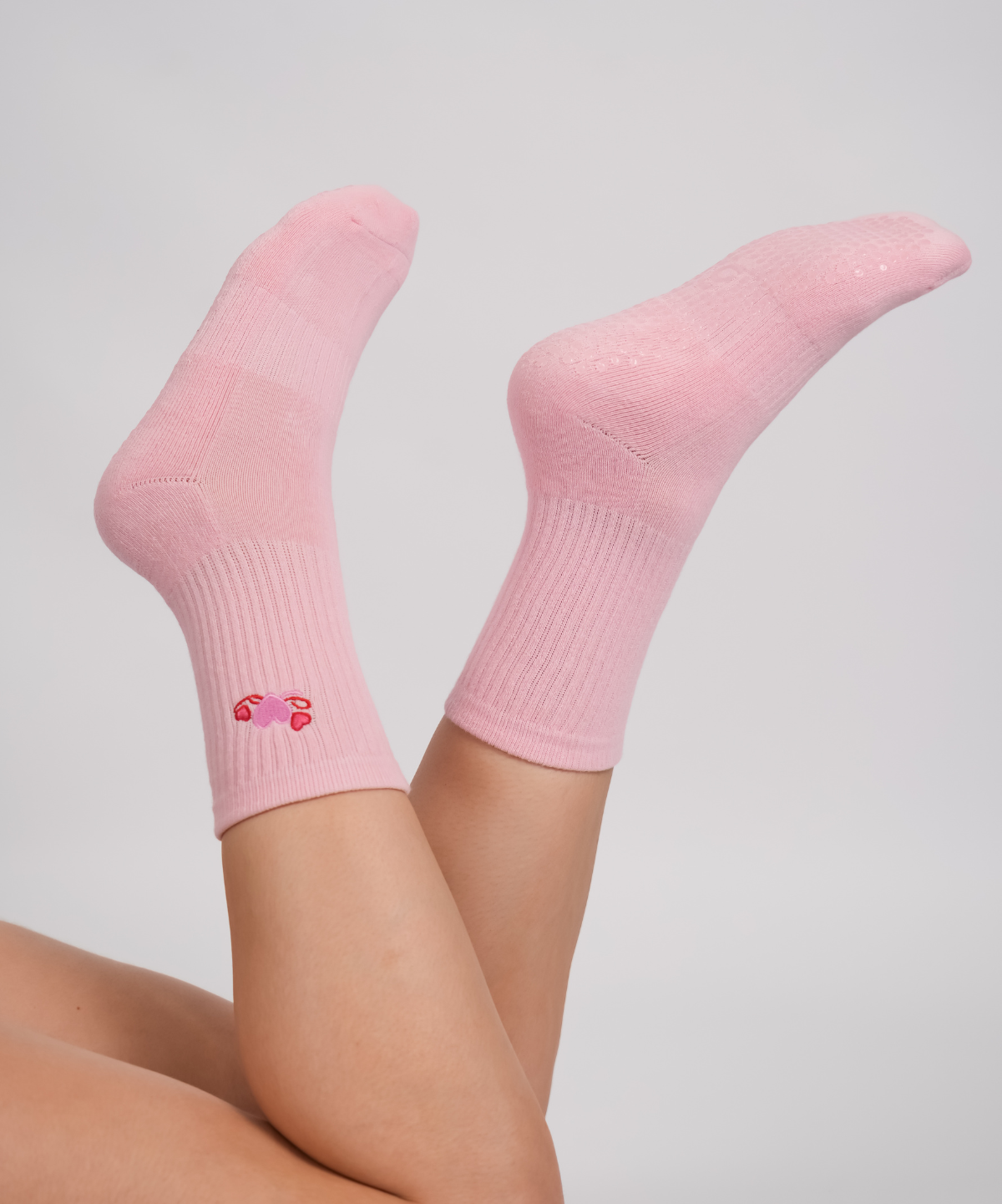 Pink socks with a small design on a light gray background