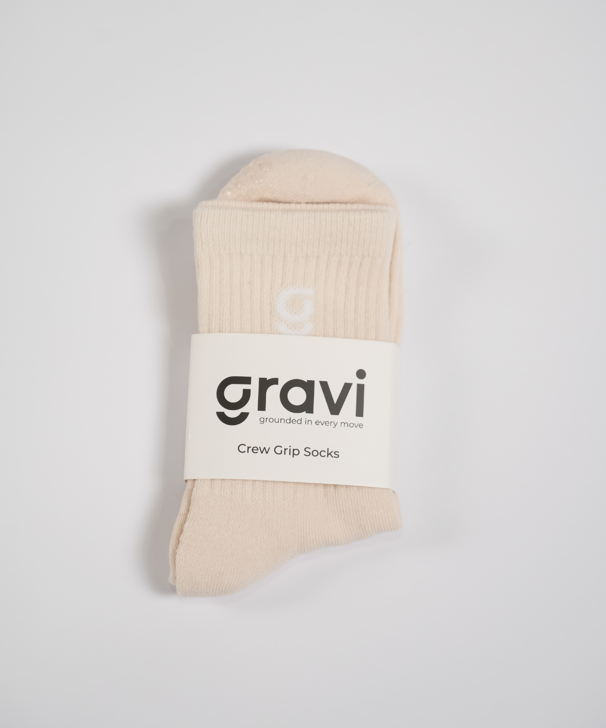 Beige grip socks with 'g' embroidery and gravi packaging