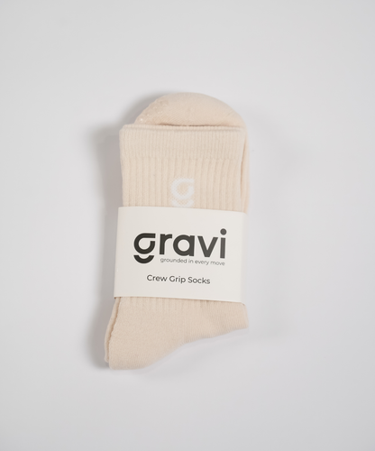 Beige grip socks with 'g' embroidery and gravi packaging