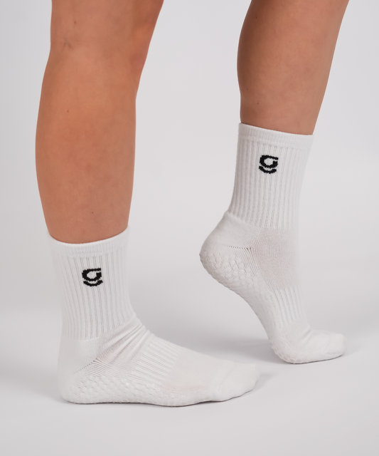 White socks with a logo on a neutral background